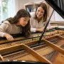 Curious preteen exploring the inside of a grand piano
