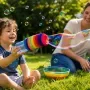 Preschool child making a rainbow bubble snake